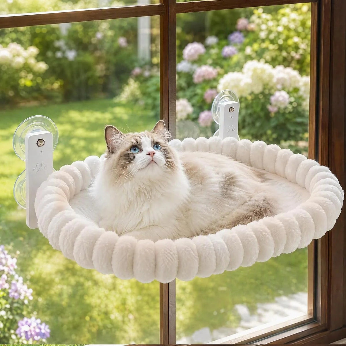 Cat resting on the window-mounted plush hammock